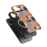 Colorblock iPhone case featuring a vibrant geometric pattern in various colors, layered over a black phone.