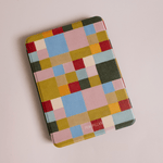 Colorblock Kindle case featuring a geometric pattern in vibrant colors like red, blue, green, and yellow.