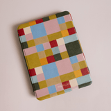 Colorblock Kindle case featuring a geometric pattern in vibrant colors like red, blue, green, and yellow.