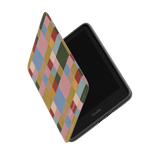 Colorblock Kindle case with a multicolored geometric design, partially open, revealing the Kindle device inside.