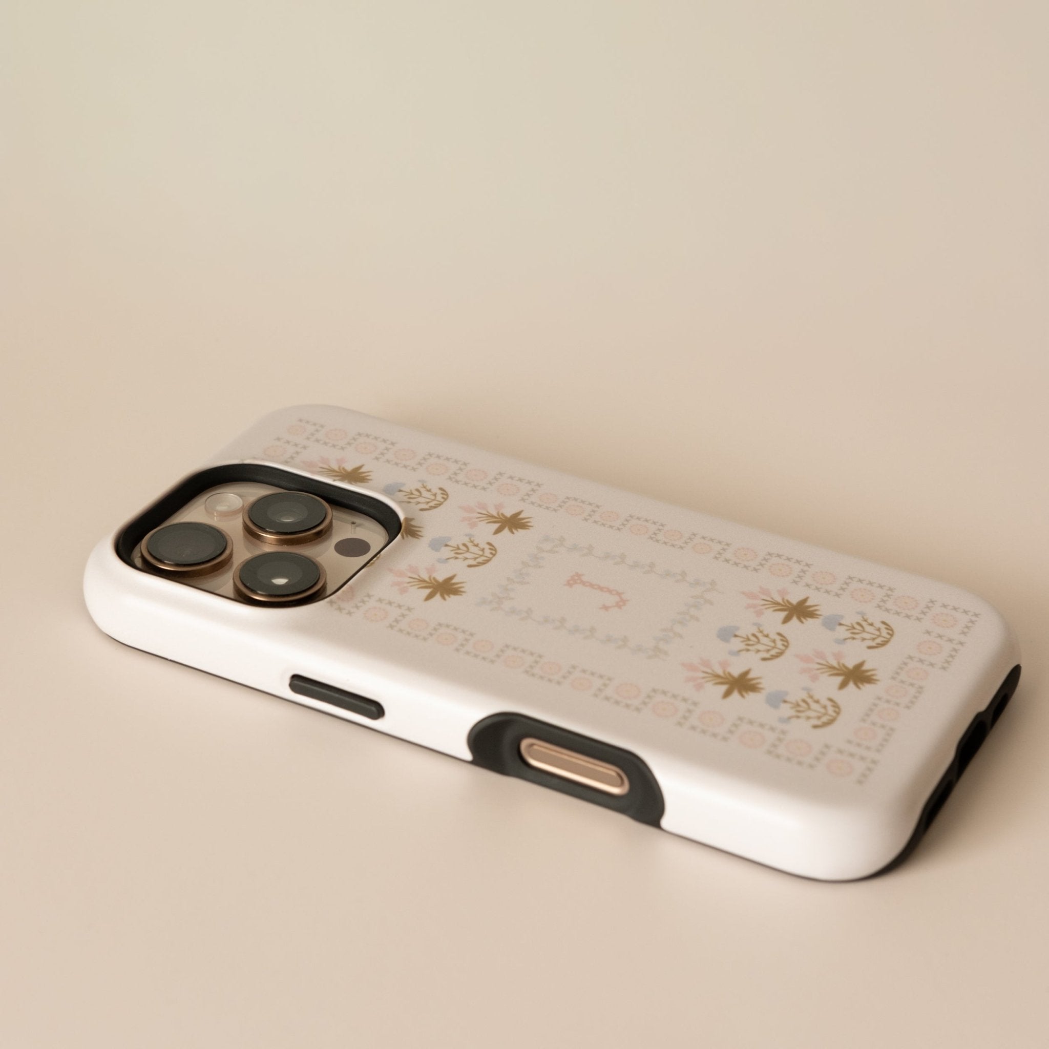 Cora personalized iPhone case featuring a floral design with gold accents on a white background.