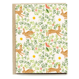 Countryside blank card featuring rabbits, flowers, and birds on a cream background with a textured kraft paper edge.