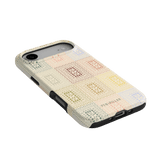 Curio iPhone case featuring a textured pattern in pastel colors on a light background with a black edge.