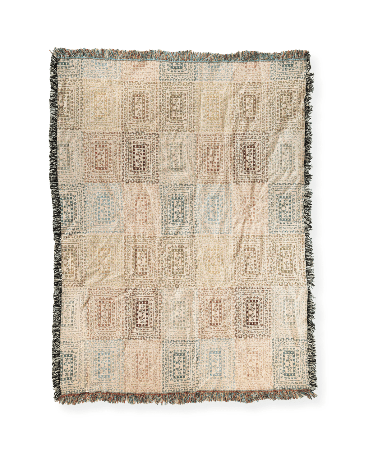 Curio woven blanket featuring a geometric pattern in soft pastel colors with fringed edges.