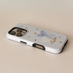 Dainty Duck personalized iPhone case with a blue striped background and a duck illustration wearing a bow.