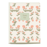 Daisy thank you card featuring pink flowers on a cream background with a green "Thank You" label in the center.