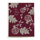 Damask holiday card featuring pomegranate and leaf designs on a burgundy background with "Warm Holiday Wishes" text.