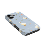Ducks iPhone case featuring a light blue background with white ducks and floral designs.