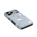Ducks iPhone case featuring a light blue background with white ducks and floral accents.