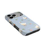 Ducks iPhone case featuring a light blue background with white ducks and floral accents.