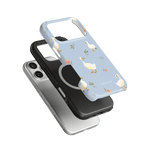 Ducks iPhone case featuring a light blue background with white ducks and floral accents, stacked with black and silver cases.