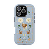 Farmland iPhone case featuring a light blue background with floral and animal illustrations, including cows and chickens.