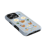 Farmland iPhone case featuring a blue background with floral and animal illustrations, including cows and chickens.