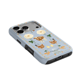 Farmland iPhone case featuring floral and animal designs on a light blue background with a black border.