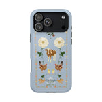 Farmland iPhone case featuring a light blue background with floral and animal illustrations, including cows and chickens.