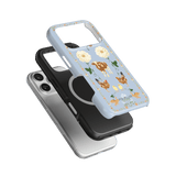Farmland iPhone case featuring a blue background with floral and animal illustrations, stacked with black and silver cases.