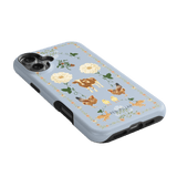 Farmland iPhone case featuring a light blue background with floral and animal illustrations, including cows and chickens.