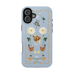 Farmland iPhone case featuring a blue background with floral designs, cows, chickens, and decorative elements.
