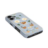 Farmland iPhone case featuring a light blue background with floral and animal illustrations, including cows and chickens.