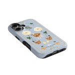 Farmland iPhone case featuring a light blue background with floral and animal illustrations, including cows and chickens.