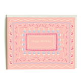 Pink birthday card featuring "Happy Birthday" text surrounded by colorful party hats and cupcakes.