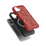 Fiona iPhone case in red with floral design, layered over black and silver cases on a green background.