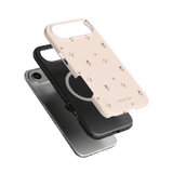 Forage iPhone case featuring a light pink design with small floral patterns, layered over a black case.