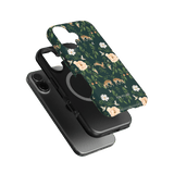 Forest iPhone case featuring a floral design with deer on a dark green background, layered over a black phone case.