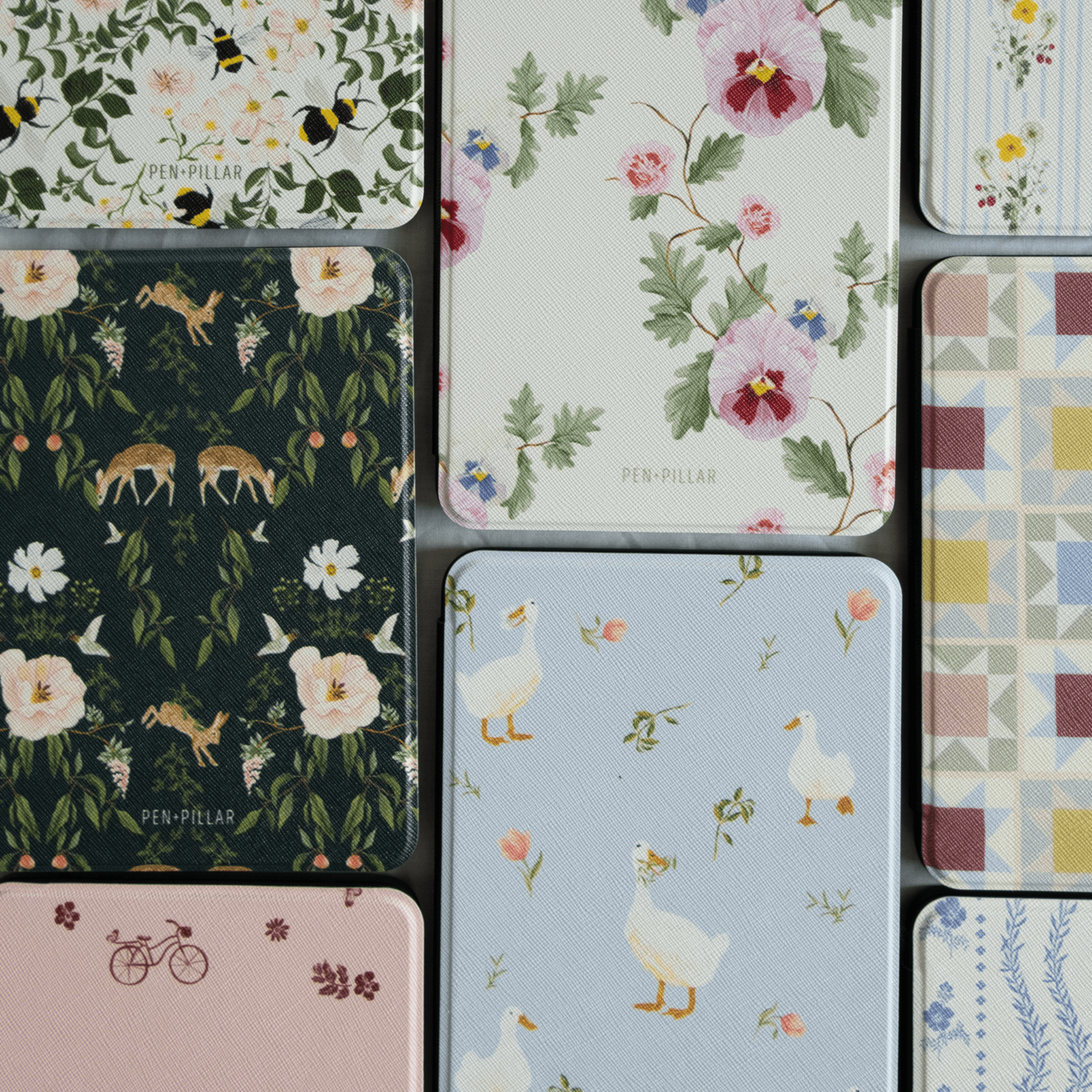 Forest Kindle case featuring floral and animal patterns in various colors and designs, arranged in a grid layout.