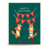 Foxy lady birthday card featuring two illustrated foxes with a birthday banner and festive accessories on a green background.