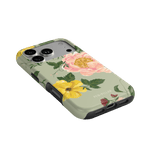 Garden Rose iPhone case featuring pink and yellow floral designs on a light green background, angled view showing ports.