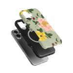 Garden Rose iPhone case featuring a floral design with pink and yellow roses on a green background, layered over a black c...
