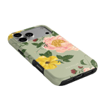 Garden Rose iPhone case featuring pink and yellow floral designs on a light green background.