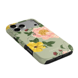 Garden Rose iPhone case featuring pink and yellow floral designs on a light green background.