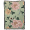 Garden rose woven blanket featuring large floral patterns in pink and yellow on a green background with fringe edges.