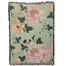 Garden rose woven blanket featuring large floral patterns in pink and yellow on a green background with fringe edges.
