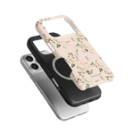 Grove iPhone case set featuring a floral design, a black case, and a clear case on a green background.