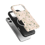 Grove iPhone case featuring a floral design in soft pink with green accents, layered over a black and silver case.