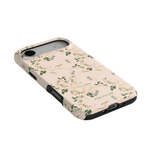 Grove iPhone case featuring a floral design in soft pink with green leaves and black edges.