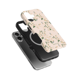 Grove iPhone case featuring a floral design in soft colors, layered over a black protective case.