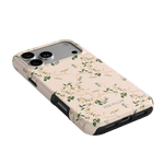 Grove iPhone case with a floral design on a light pink background, featuring cutouts for camera and ports.