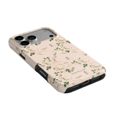 Grove iPhone case with a floral design on a light pink background, featuring cutouts for camera and ports.