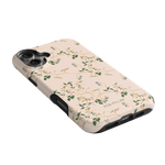 Grove iPhone case featuring a floral design on a light pink background with black edges and camera cutouts.