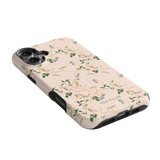 Grove iPhone case featuring a floral design on a light pink background with black edges and camera cutouts.