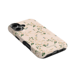 Grove iPhone case featuring a floral design on a light pink background with black edges.