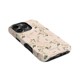 Grove iPhone case featuring a floral design on a light pink background with black edges.