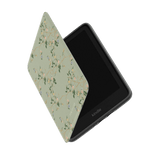 Grove Kindle case with a floral design in soft green, partially open to reveal the Kindle device inside.