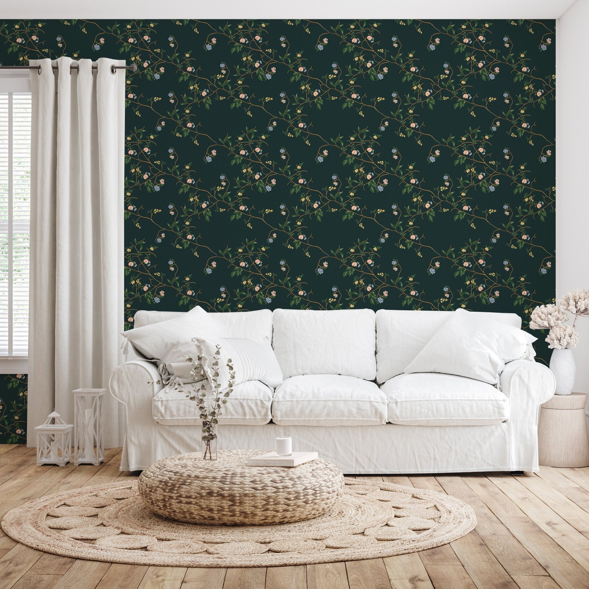 Dark green Grove wallpaper with a floral vine pattern behind a white fabric sofa and woven rug.