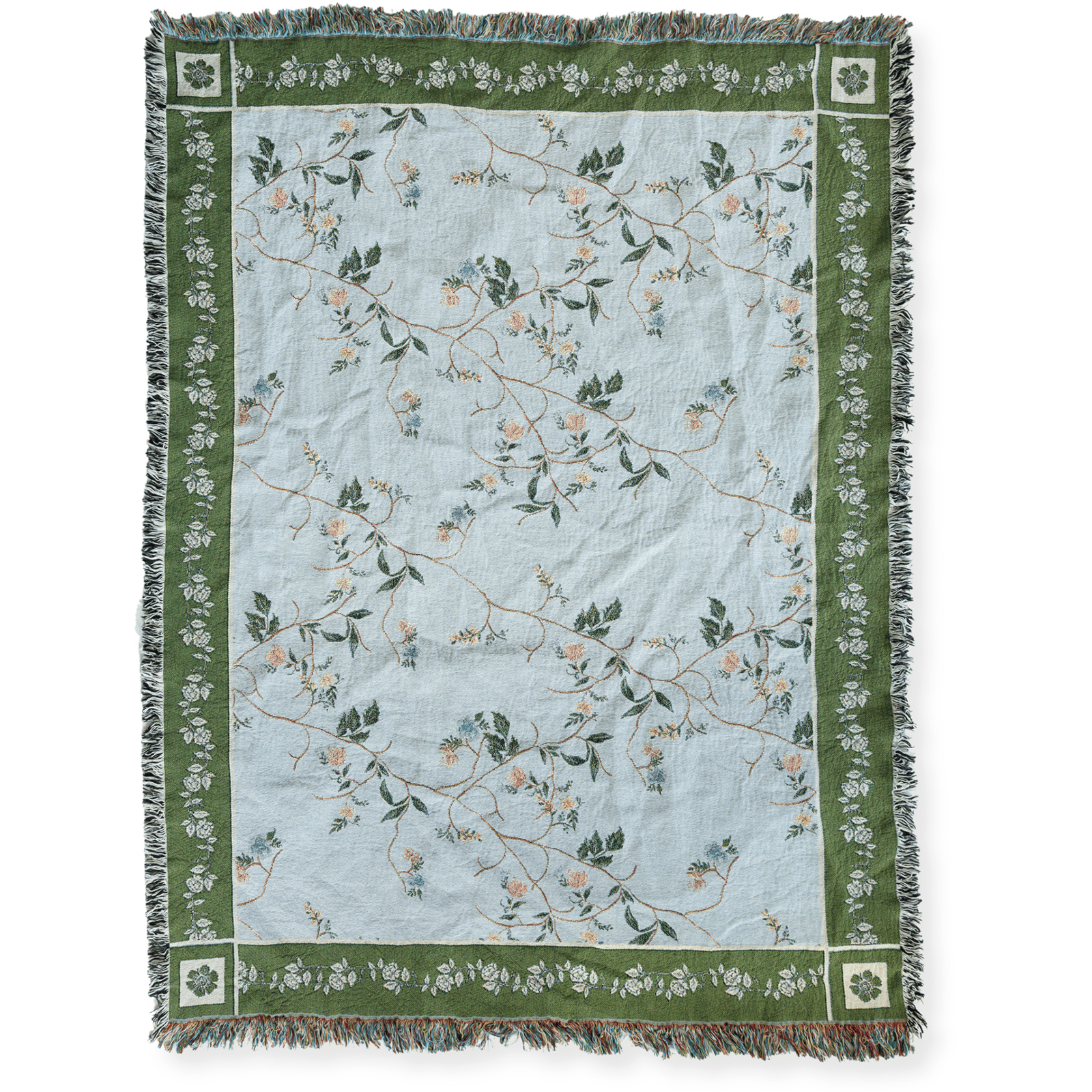 Grove woven blanket featuring a light blue background with floral patterns and green borders, fringed edges.