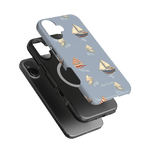 Harbor iPhone case featuring a light blue background with sailboat designs and a black phone case underneath.